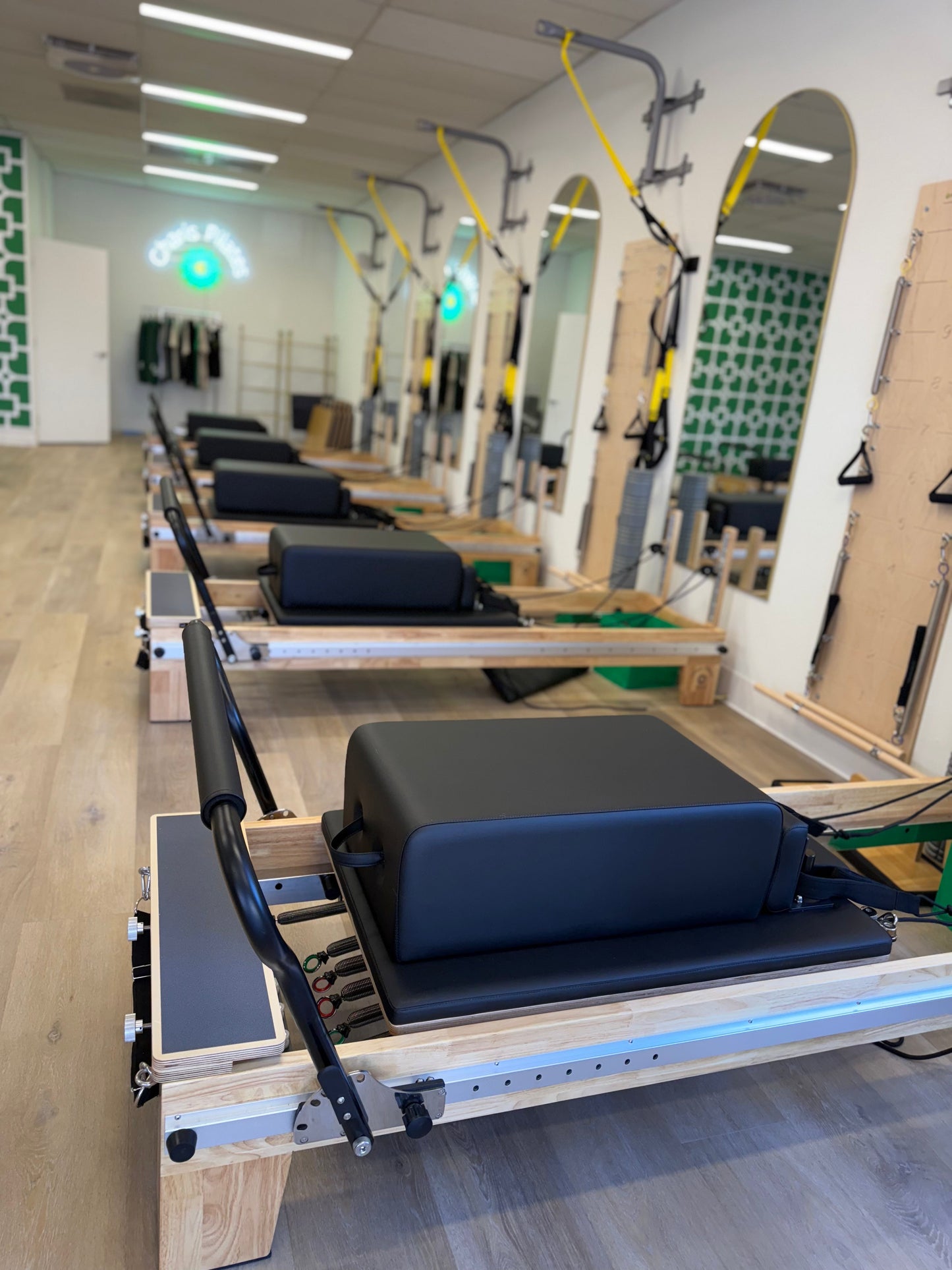 Pilates reformer with full-length footbar for expanded exercise options in studio classes