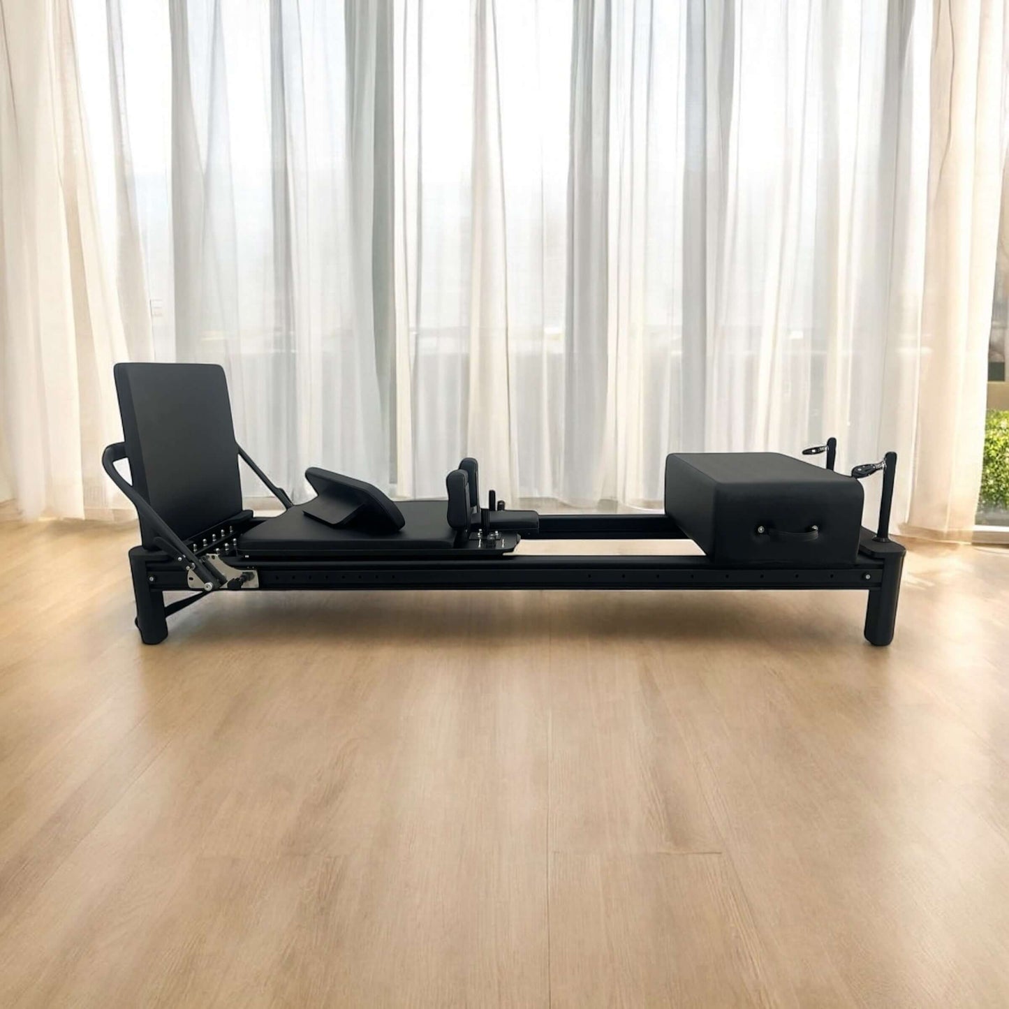 Full Track Queen Pilates reformer machine in studio setting, front view